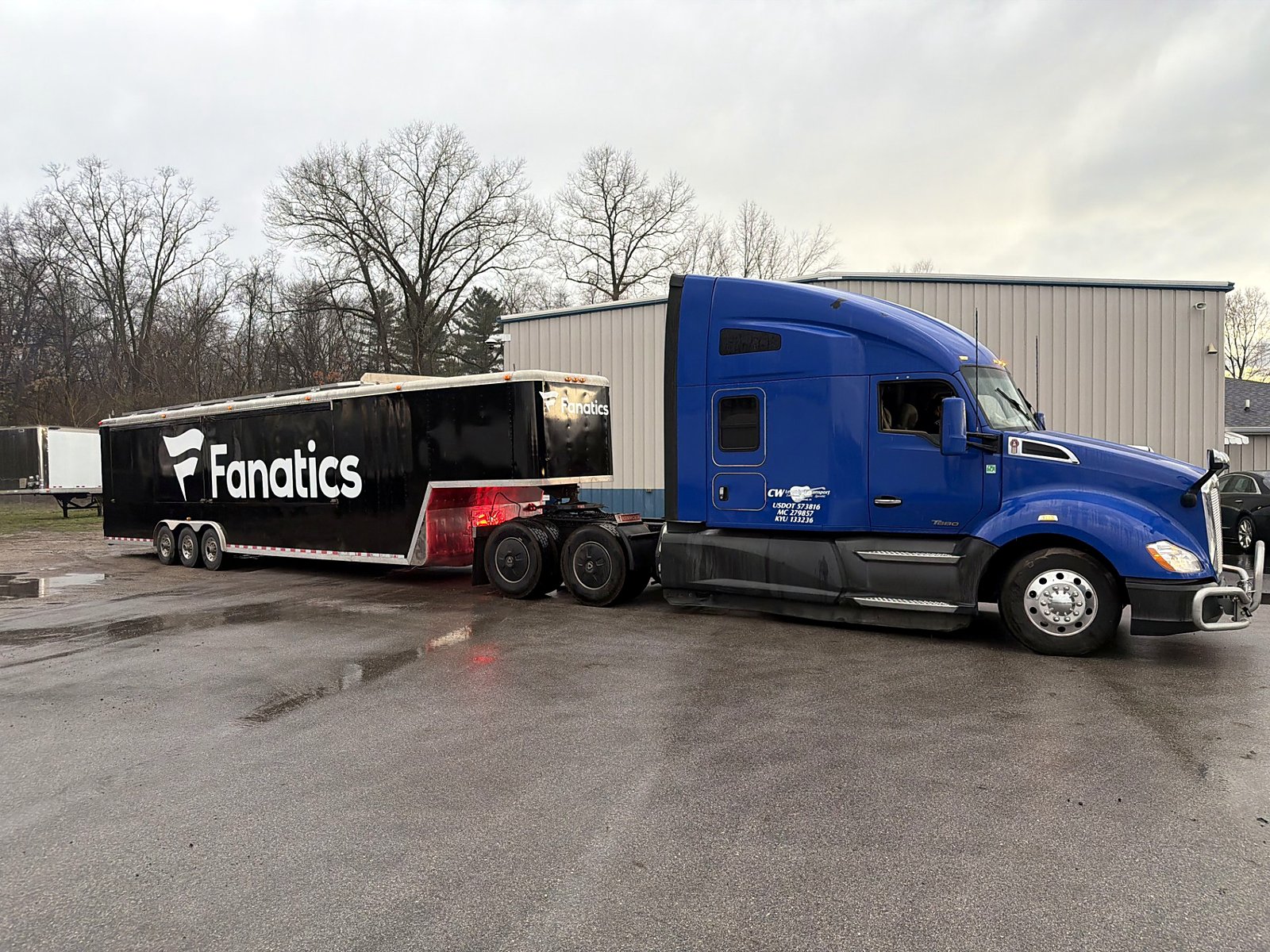 Fanatics trailer behind a blue CW tractor